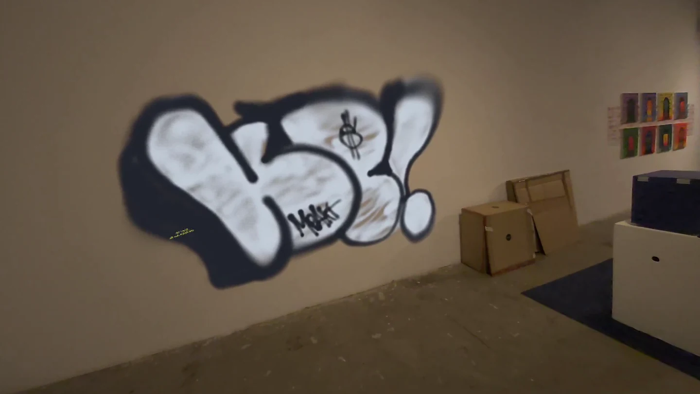 A finished white-and-black virtual graffiti piece on a real room wall